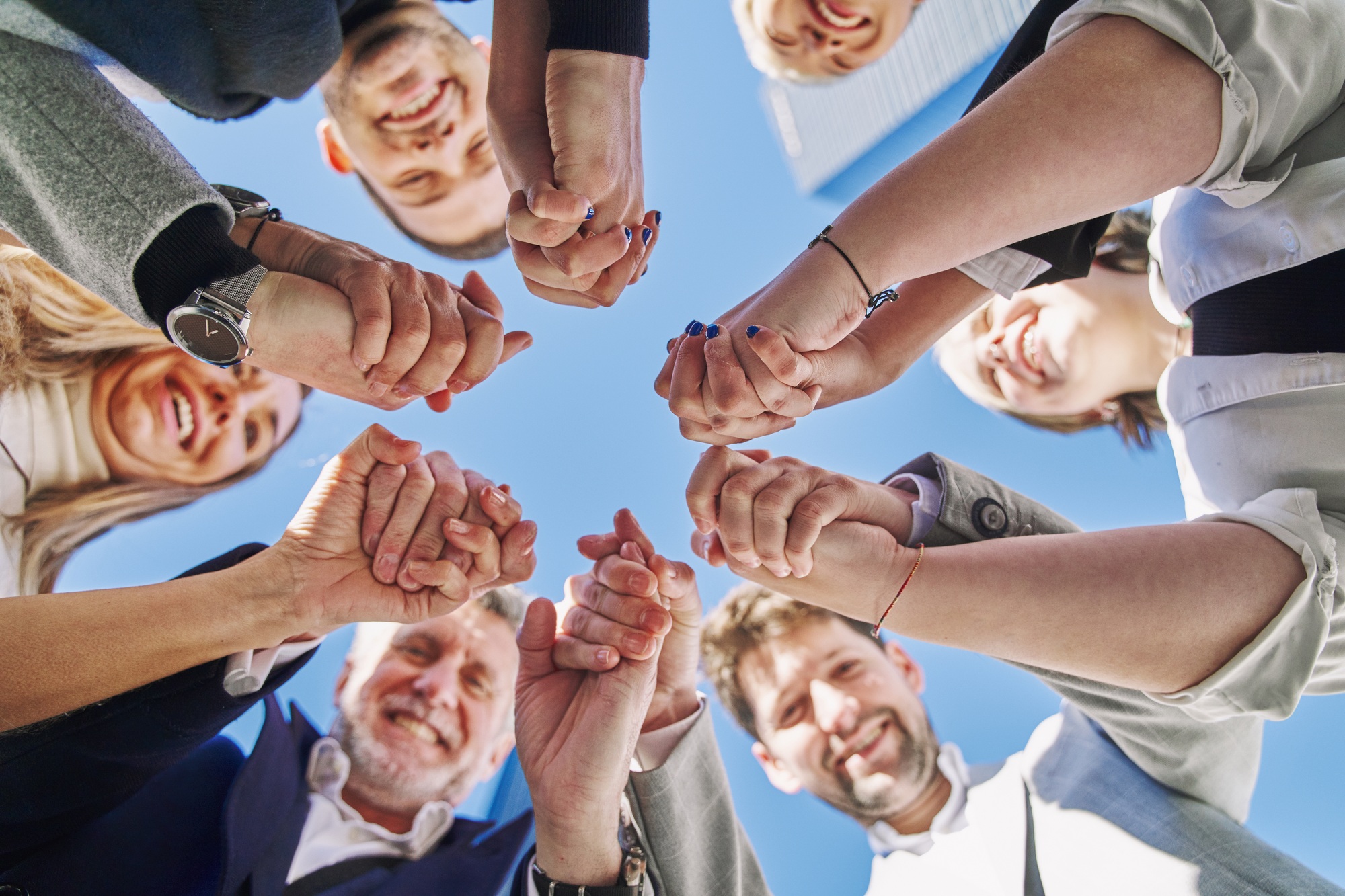 Close up of hands of business team holding together, unity teamwork support concept