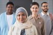 Young Muslim female voter in hijab standing in front of group of people